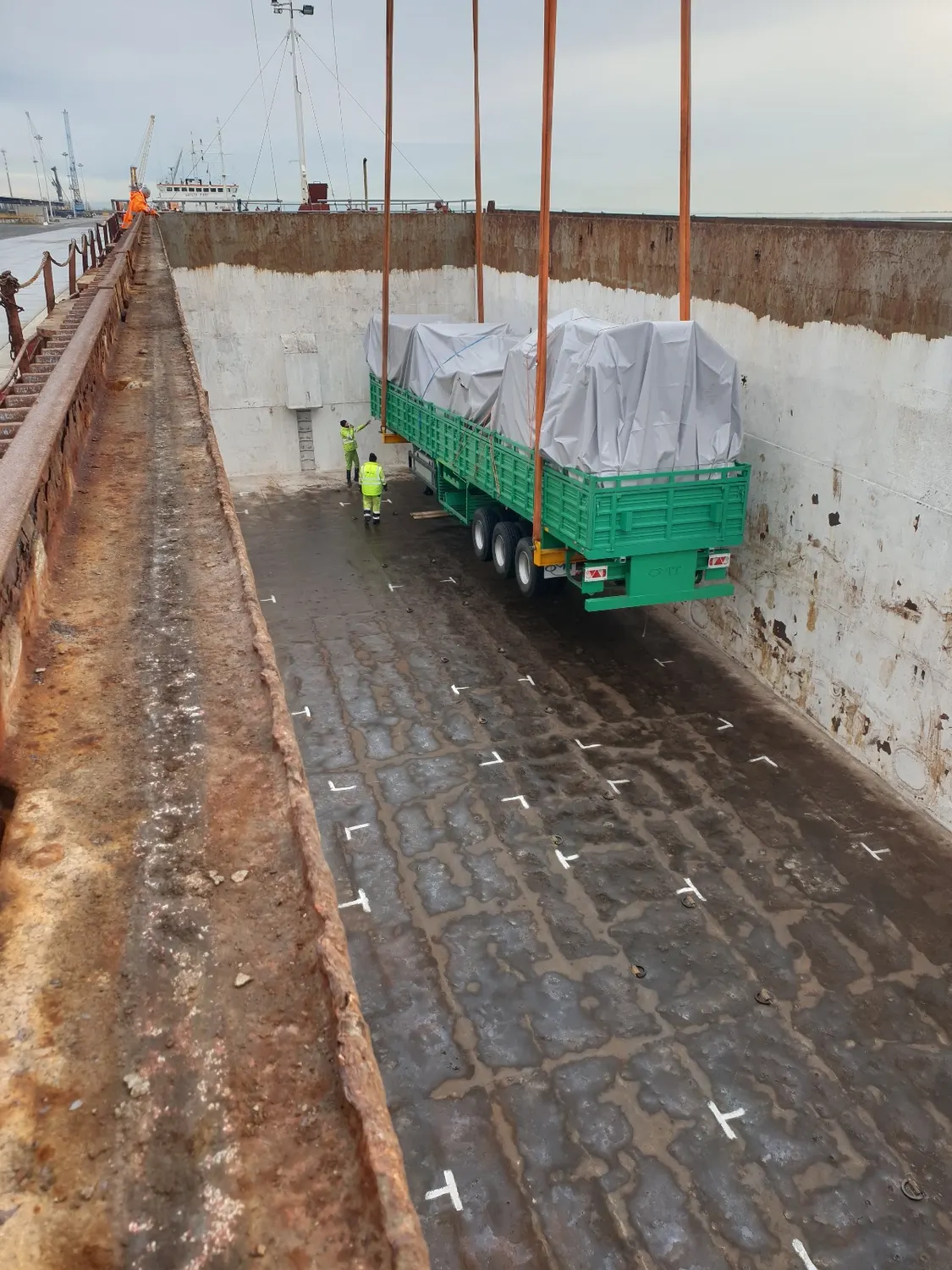 Trailers being loaded into the hold of a vessel